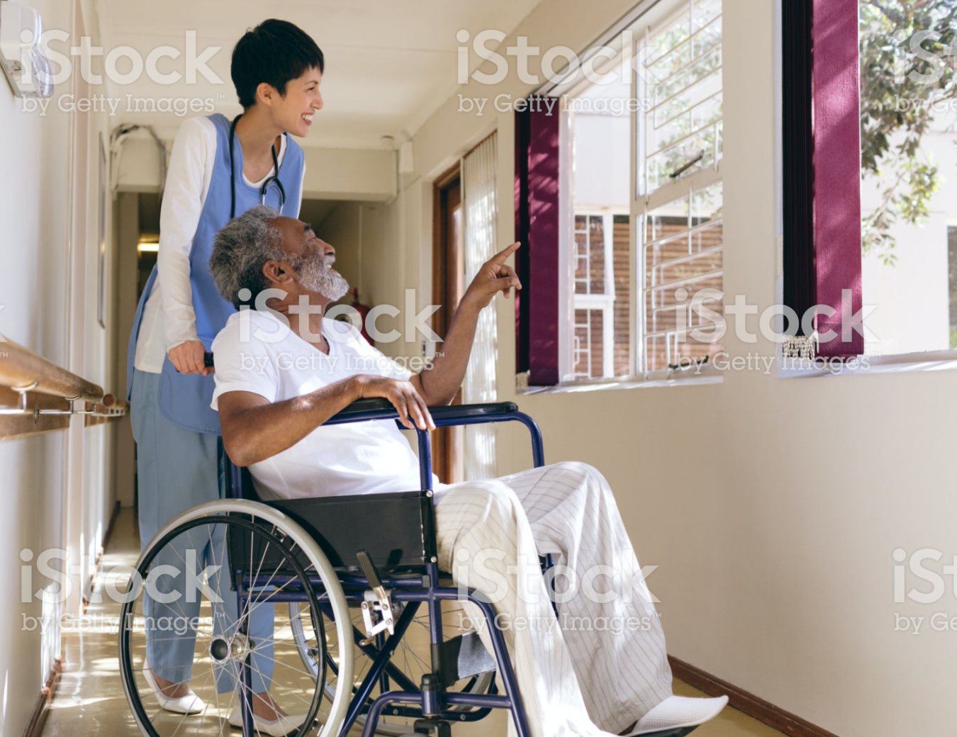 Employee walks with a Female Elderly Patient